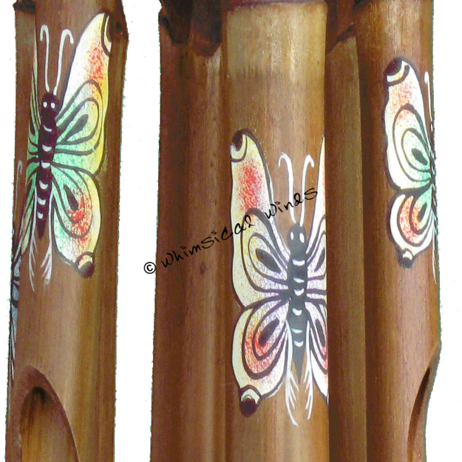 Bamboo wind chime tubes zoomed in with butterfly designs on a white background