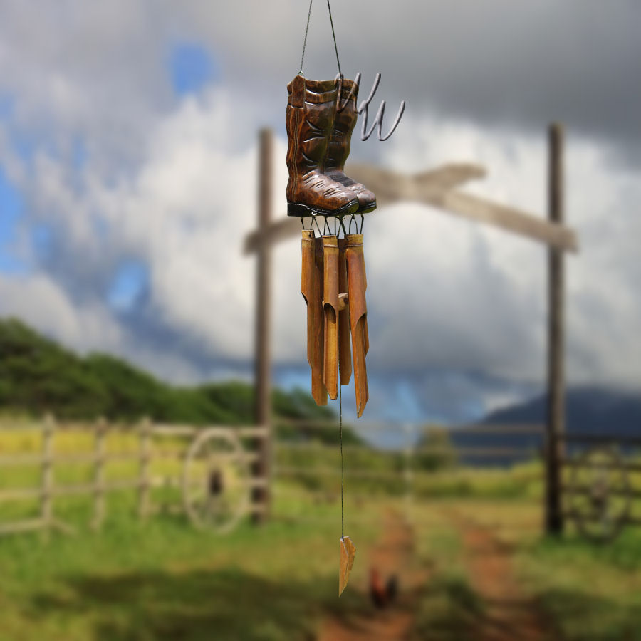 Wooden boot-shaped ornament ON TOP OF BAMBOO TUBES with 'Whimsical Winds' branding against a green foliage background.