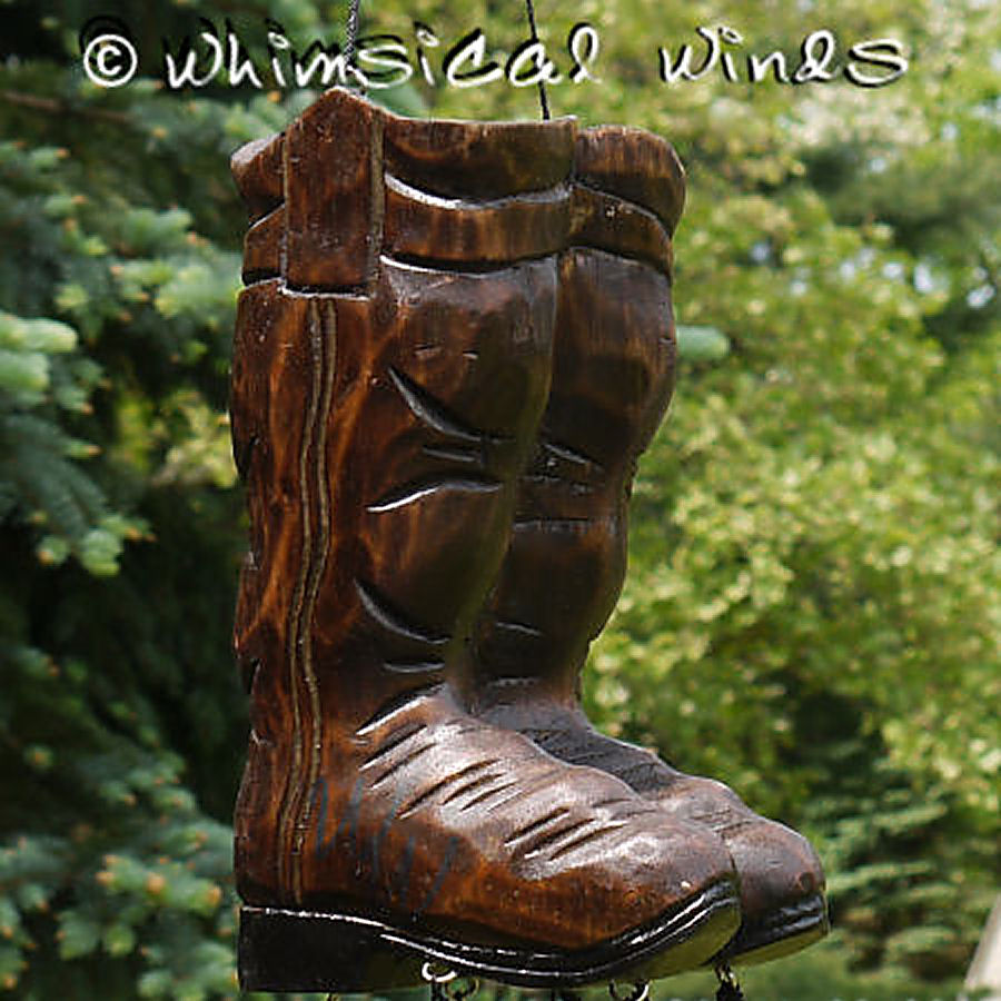 Wooden boot-shaped ornament with 'Whimsical Winds' branding against a green foliage background.
