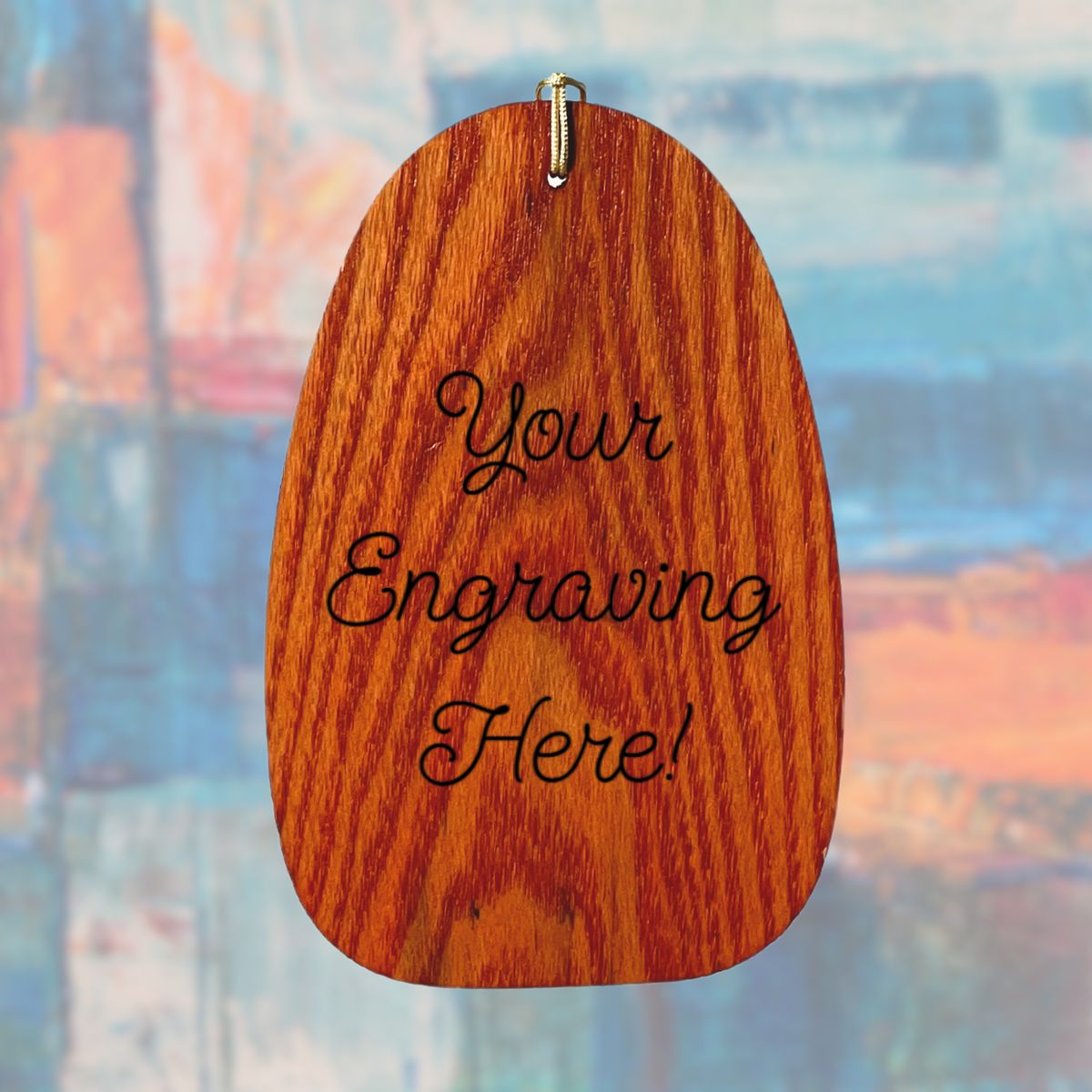 Wooden wind sail with 'Your Engraving Here!' text on a blurred abstract background