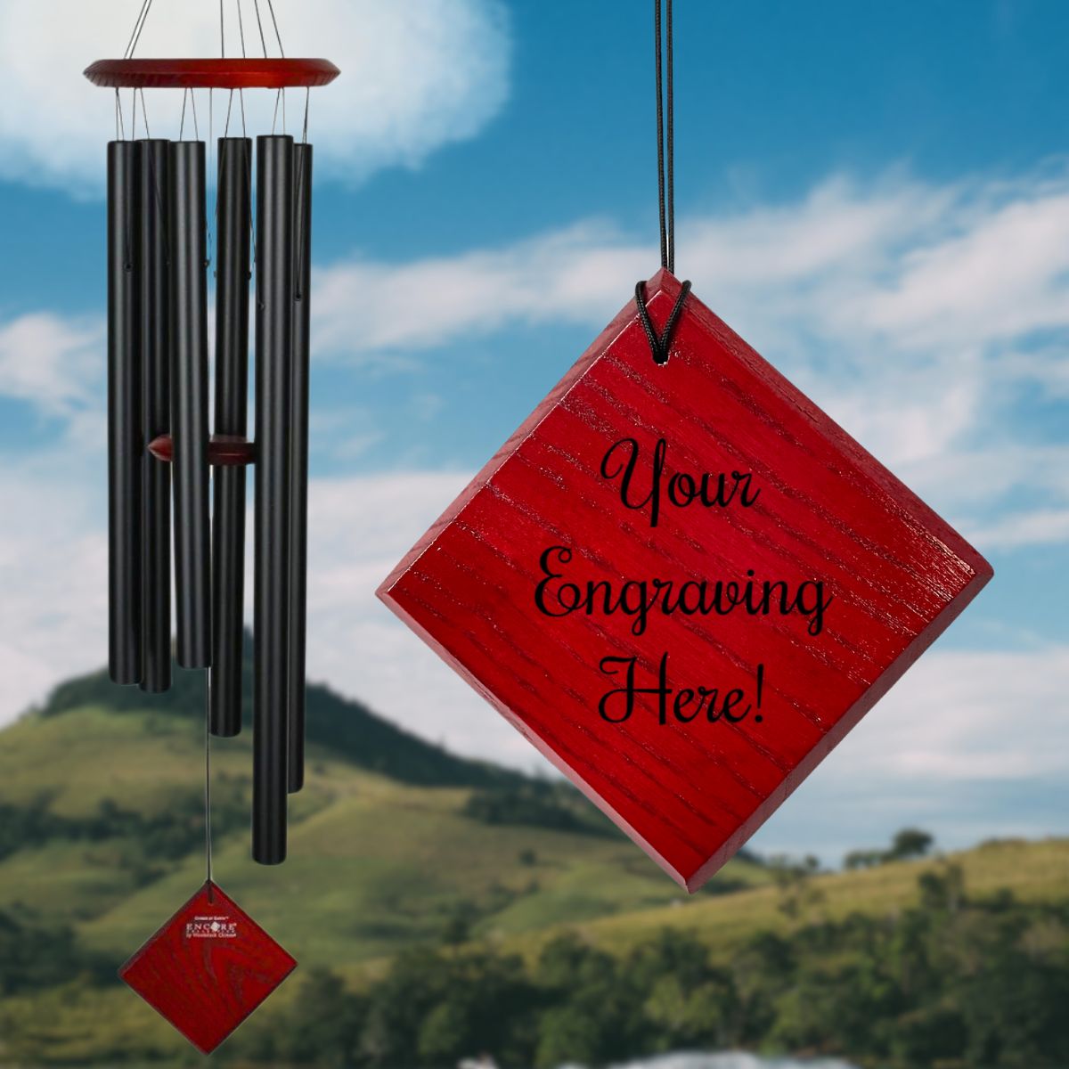 Woodstock brand 'Chimes of the Eclipse' BLACK aluminum tubes wind chime that is 37 inches in length, with customizable red wooden wind sail displayed in front of a landscape background