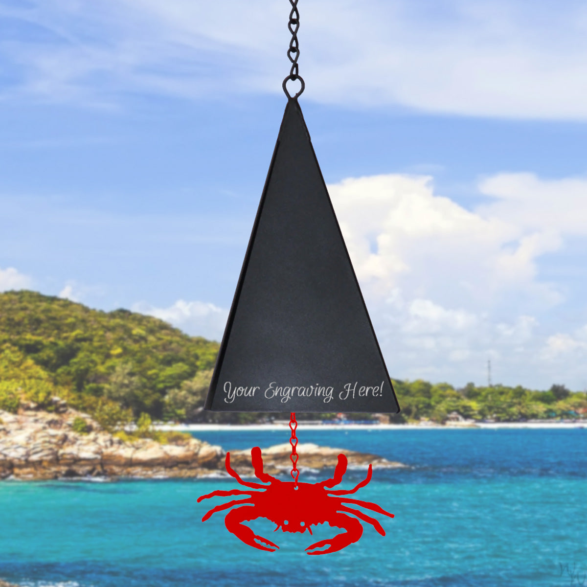 North Country Island Pasture Buoy Bell – engraved version featuring an 8-inch powder‑coated recycled steel bell in a triangular shape WITH CUSTOMIZABLE ENGRVAING, hanging from jack chain with RED CRAB windcatcher sailing below; finished in matte black that weathers into rich rust tones
