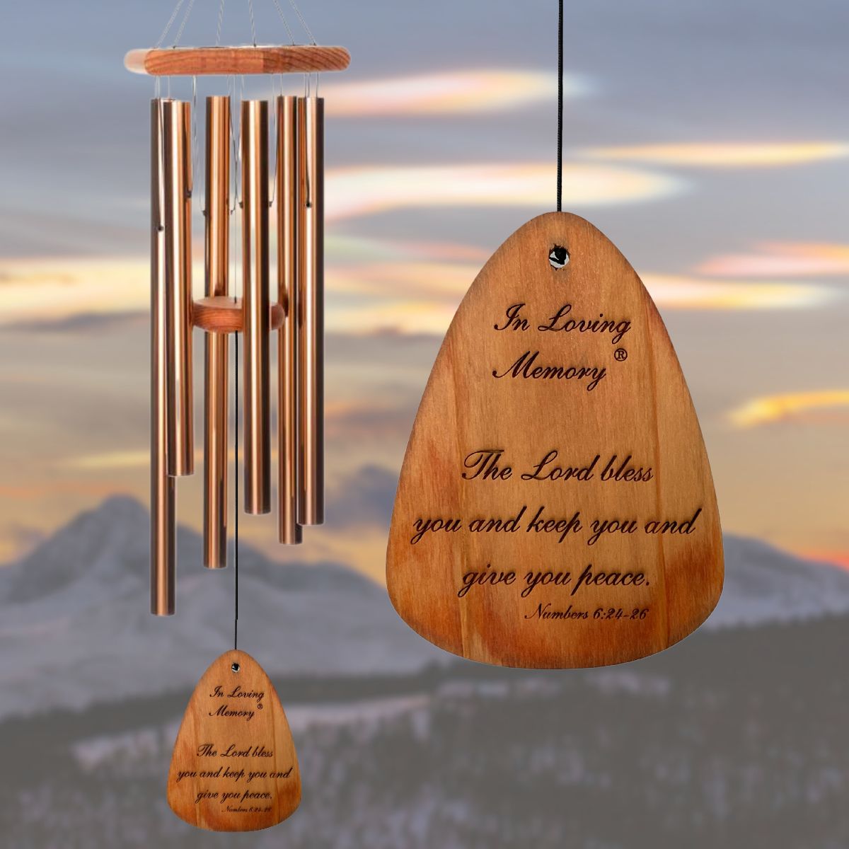 In Loving Memory BRAND wind chime THAT IS 35 inches WITH BRONZE ALUMINUM TUBES PRE-ENGRAVED with THE QUOTE, "THE LORD BLESS YOU AND KEEP YOU AND GIVE YOU PEACE. NUMBERS 6:24-26" ON THE WIND SAIL, ALL OF WHICH IS DISPLAYED IN FRONT OF A LANDSCAPE BACKGROUND