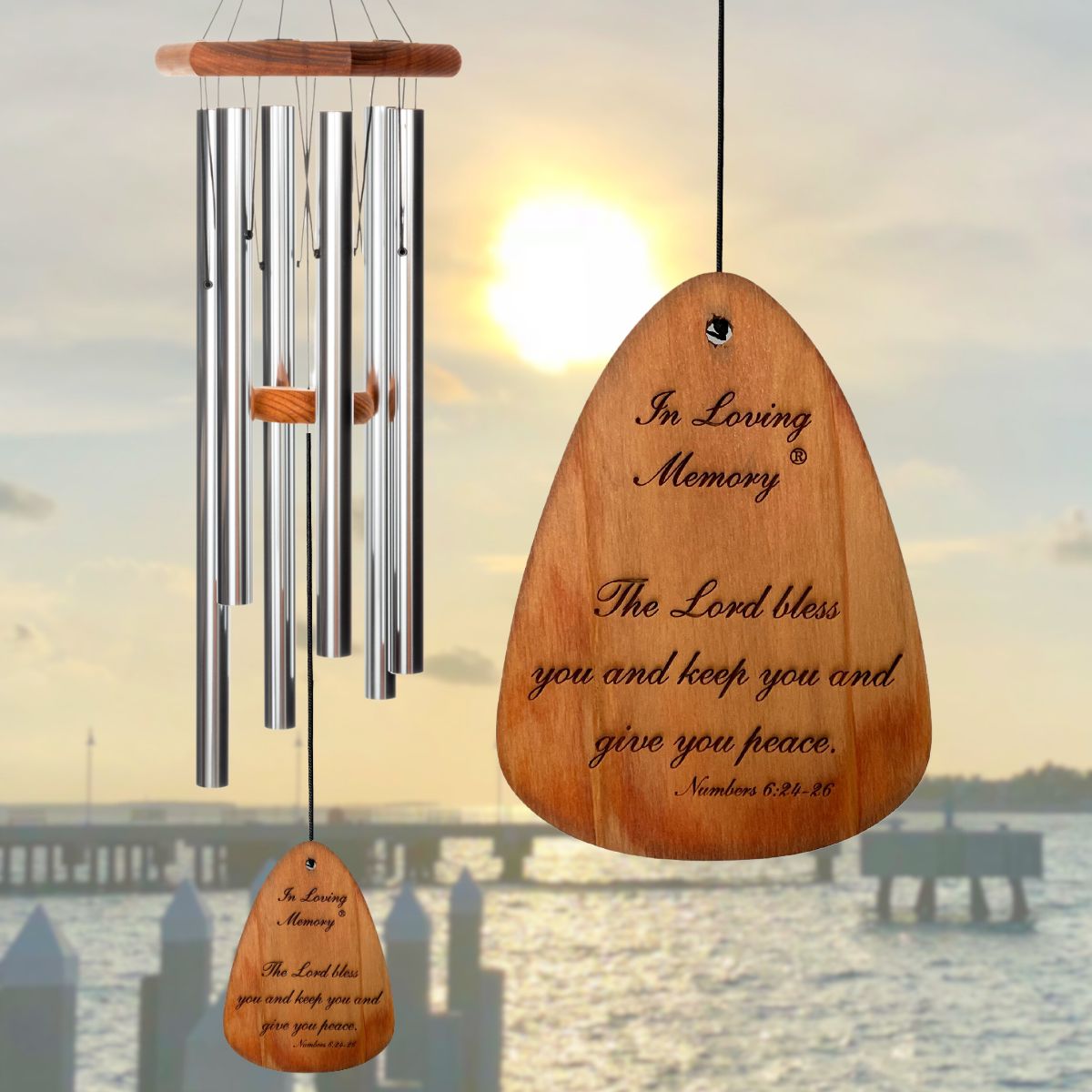 In Loving Memory BRAND wind chime THAT IS 35 inches WITH SILVER ALUMINUM TUBES PRE-ENGRAVED with THE QUOTE, "THE LORD BLESS YOU AND KEEP YOU AND GIVE YOU PEACE. NUMBERS 6:24-26" ON THE WIND SAIL WHICH IS DISPLAYED IN FRONT OF A LANDSCAPE BACKGROUND