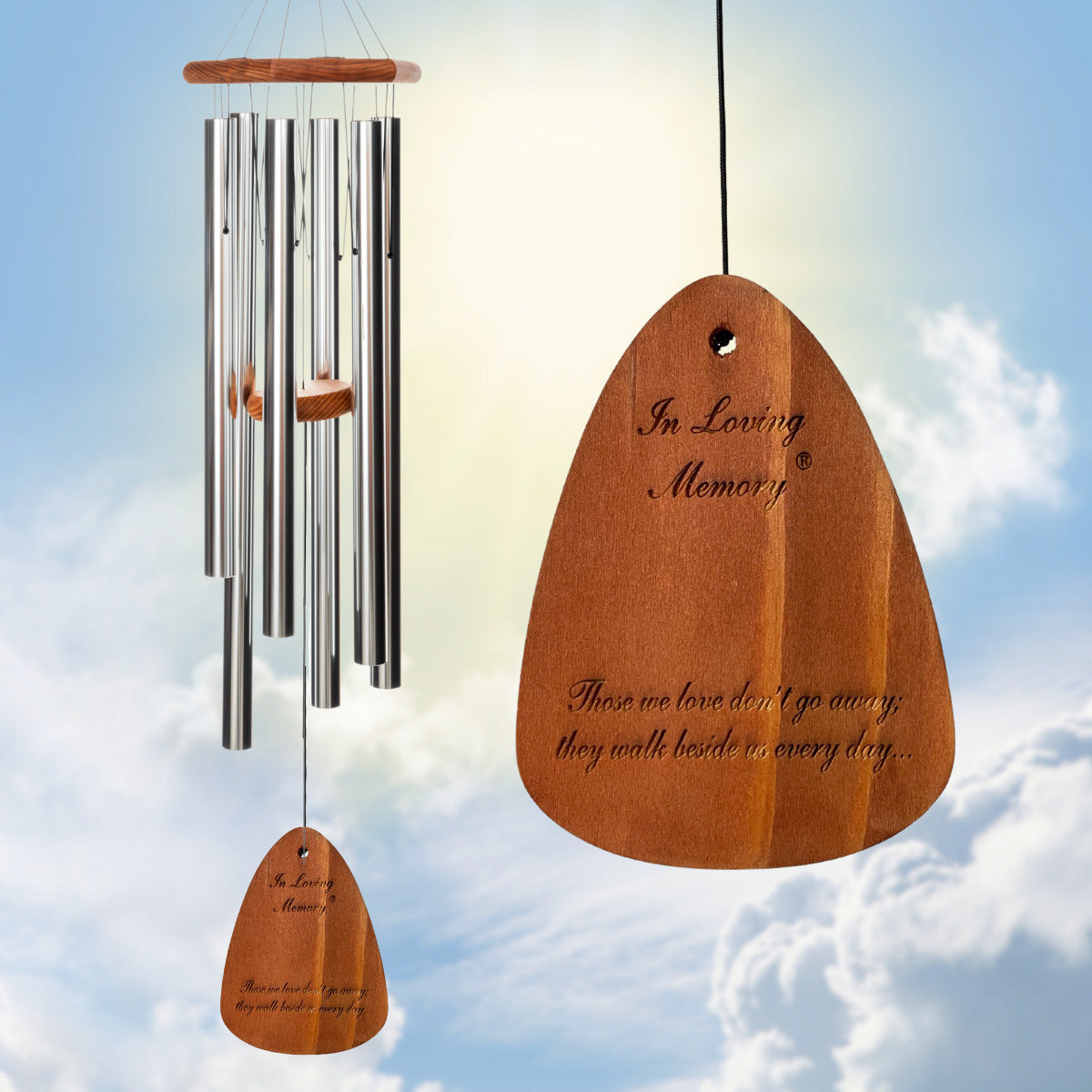 In Loving Memory 42 inch silver wind chime with "Those we love don't go away, they walk beside us every day" message against a blue sky background