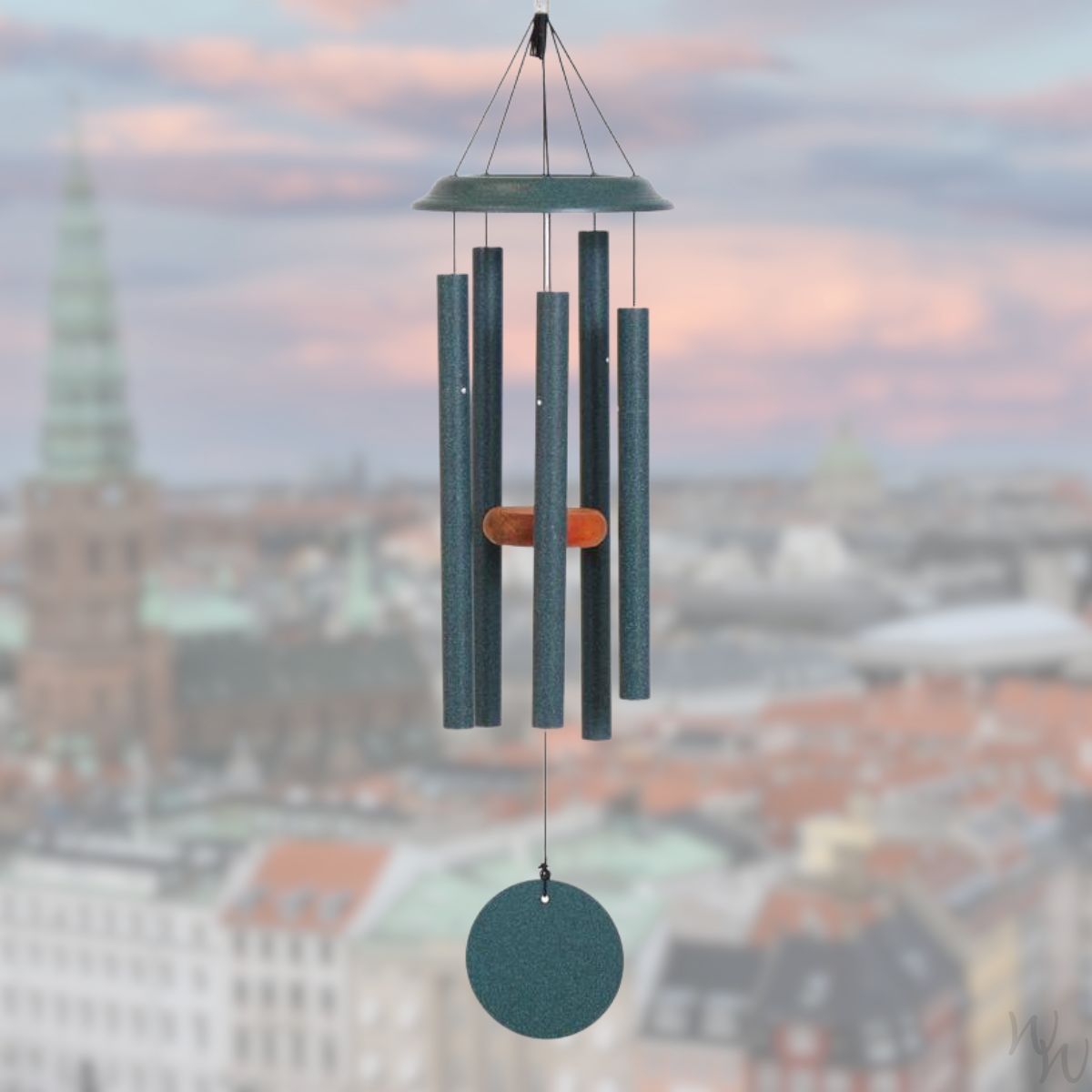 Shenandoah brand wind chime that is colored green, 29 inches, has 5 aluminum tubes, and a wooden striker displayed in front of a landscape background