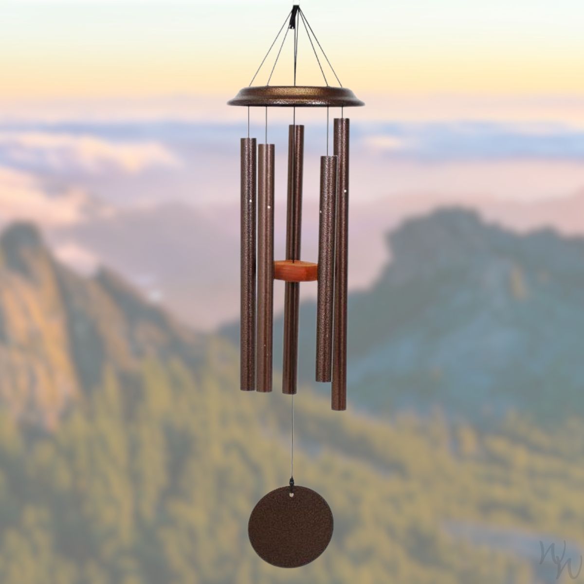 Shenandoah brand wind chime that is colored copper, 35 inches, has 5 aluminum tubes, and a wooden striker displayed in front of a landscape background