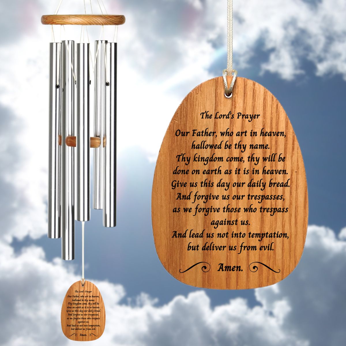 Woodstock Reflections Lord's Prayer wind chime with a wind sail that reads "Our Father, who art in heaven, hallowed be thy name. Thy kingdom come, thy will be done on earth as it is in heaven. Give us this day our daily bread. And forgive our trespasses, as we forgive those who trespass against us. And lead us not into temptation, but deliver us from evil. Amen." against a cloudy sky background
