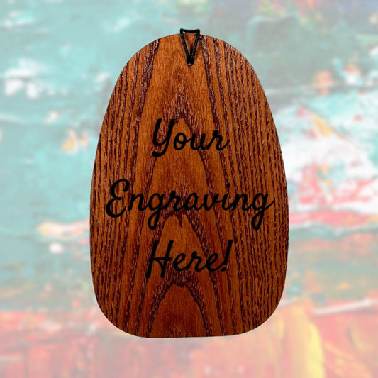 Wooden wind sail with 'Your Engraving Here!' text engraved and a colorful blurred background