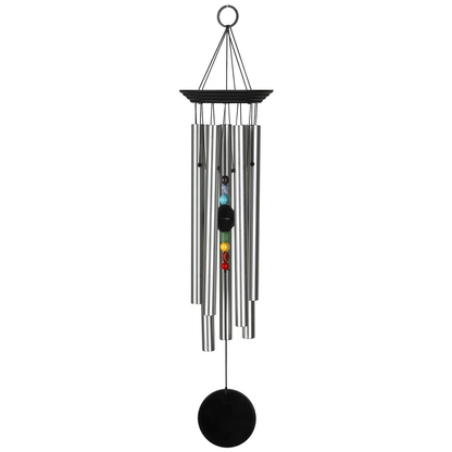 Woodstock Percussion 7‑Stone Bronze Chakra Wind Chime with engravable wooden wind sail WITH seven SILVER aluminum tubes hang from BLUE WASH finish ash‑wood top; the faceted clapper aligns seven chakra stones vertically, with a round wooden sail AND AN O RING HOOK