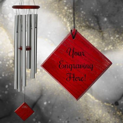 Woodstock brand 'Chimes of the Eclipse' SILVER aluminum tubes wind chime that is 37 inches in length, with customizable red wooden wind sail displayed in front of a landscape background
