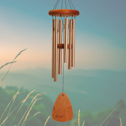 Festival 24 inch bronze wind chime with wooden striker and wind sail, with a blurred natural background