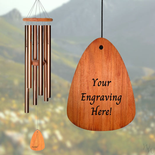 Festival 42 inch bronze wind chime with wooden striker and wind sail, with customizable engraving on a blurred natural background