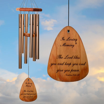 In Loving Memory BRAND wind chime THAT IS 30 inches WITH BRONZE ALUMINUM TUBES PRE-ENGRAVED with THE QUOTE, "THE LORD BLESS AND KEEP YOU AND GIVE YOU PEACE. NUMBERS 6:24-26" ON THE WIND SAIL, ALL OF WHICH IS DISPLAYED IN FRONT OF A LANDSCAPE BACKGROUND