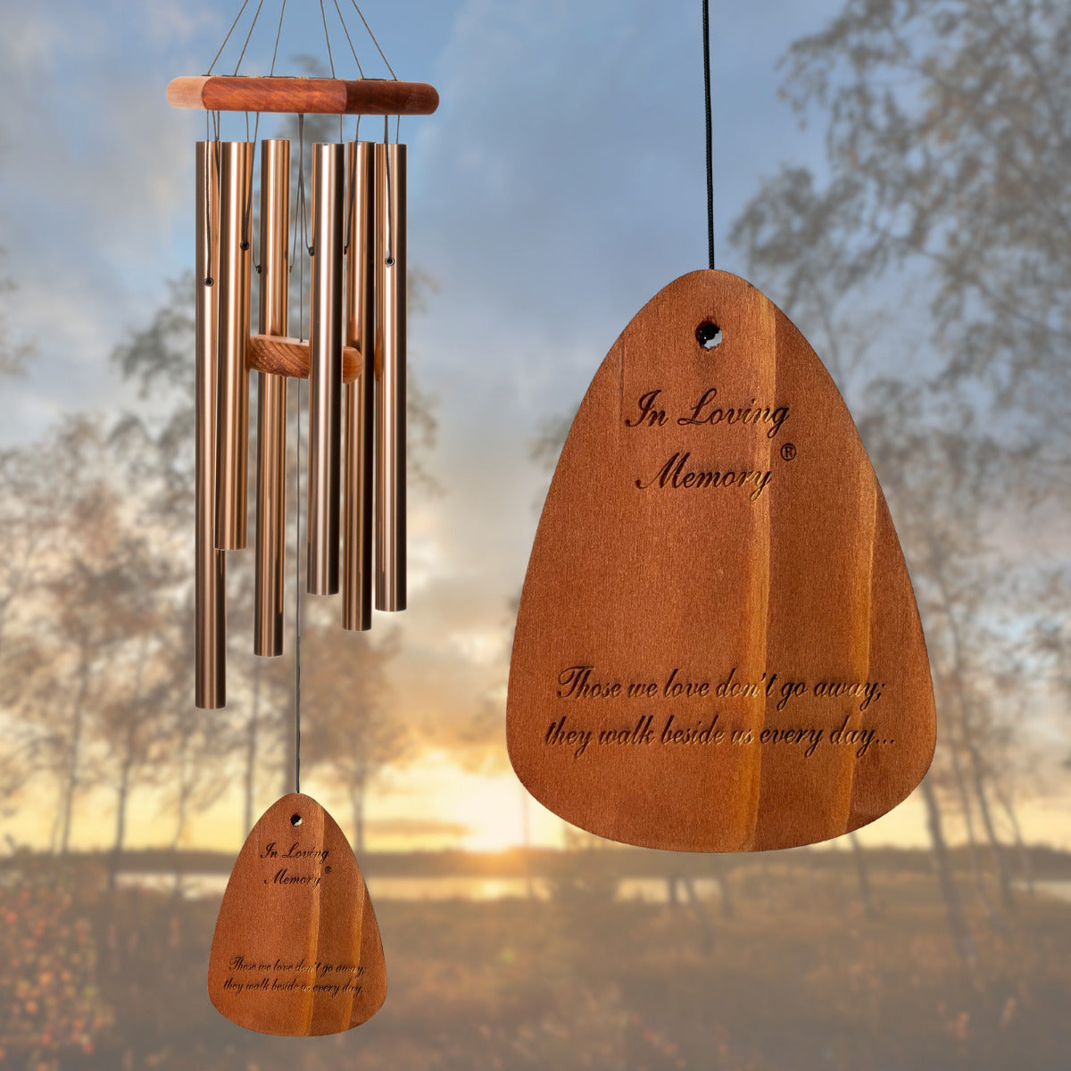 In Loving Memory BRAND wind chime THAT IS 30 inches WITH BRONZE ALUMINUM TUBES PRE-ENGRAVED with THE QUOTE, "THOSE WE LOVE DON'T GO AWAY; THEY WALK BESIDES US EVERY DAY..." ON THE WIND SAIL, ALL OF WHICH IS DISPLAYED IN FRONT OF A LANDSCAPE BACKGROUND