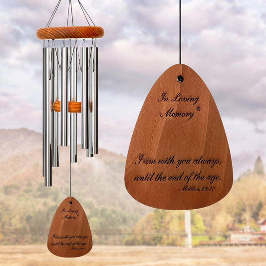 In Loving Memory BRAND wind chime THAT IS 18 inches WITH SILVER ALUMINUM TUBES PRE-ENGRAVED with THE QUOTE, "I AM WITH YOU ALWAYS, UNTIL THE END OF THE AGE. MATTHEW 28:20" ON THE WIND SAIL, ALL OF WHICH IS DISPLAYED IN FRONT OF A LANDSCAPE BACKGROUND