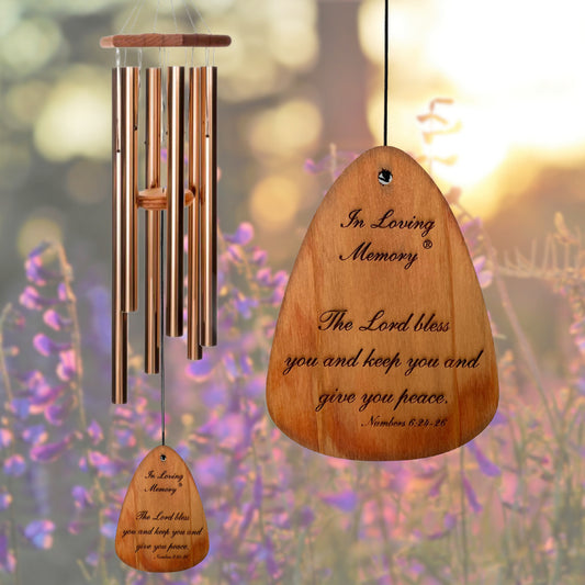 In Loving Memory 42 inch bronze wind chime with "In Loving Memory The Lord bless you and keep you and give you peace. Numbers 6:24-25" inscribed on the wind sail, against a blurred natural background 