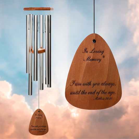 In Loving Memory 42 inch silver wind chime with a "I am with you always, until the end of the age Matthew 28:20" engraving, against a cloudy sky background