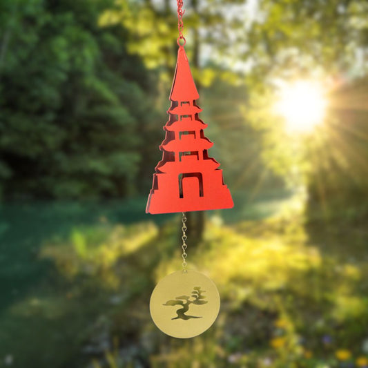 North Country Utau Meditation Buoy Bell — vibrant red 11.25″ powder‑coated steel bell in temple‑inspired tiered design, with a golden bonsai tree cut‑out windcatcher; approx. 26.5″ total length, dual‑tone resonance for peaceful contemplation