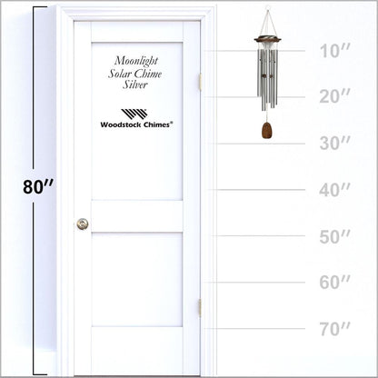 Woodstock Chimes Moonlight Silver Solar Chime displayed on a white door with height measurement scale